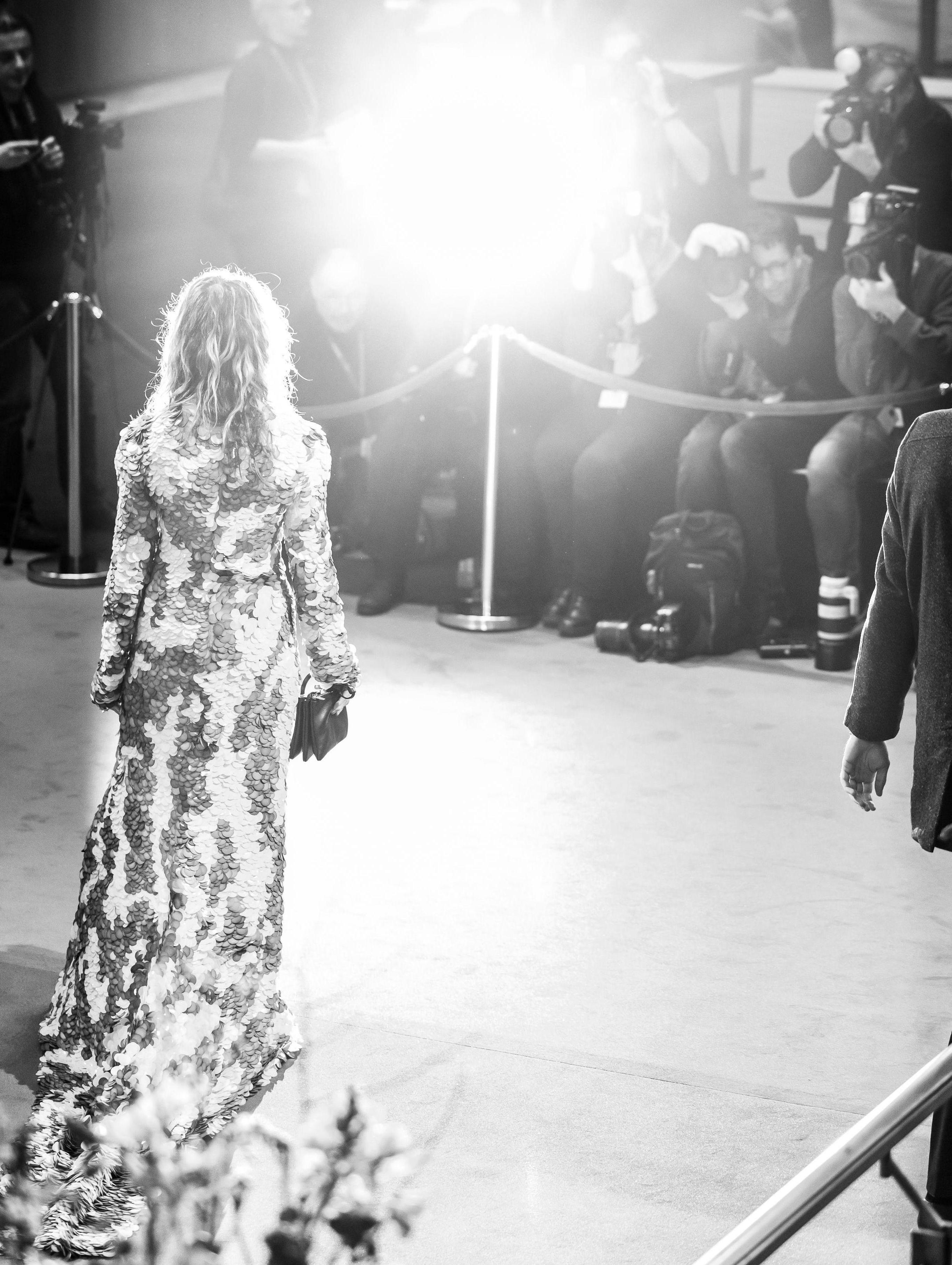 Actress Anne Ratte-Polle on the Red Carpet. She can be seen from behind, in front of her are photographers taking pictures of her.