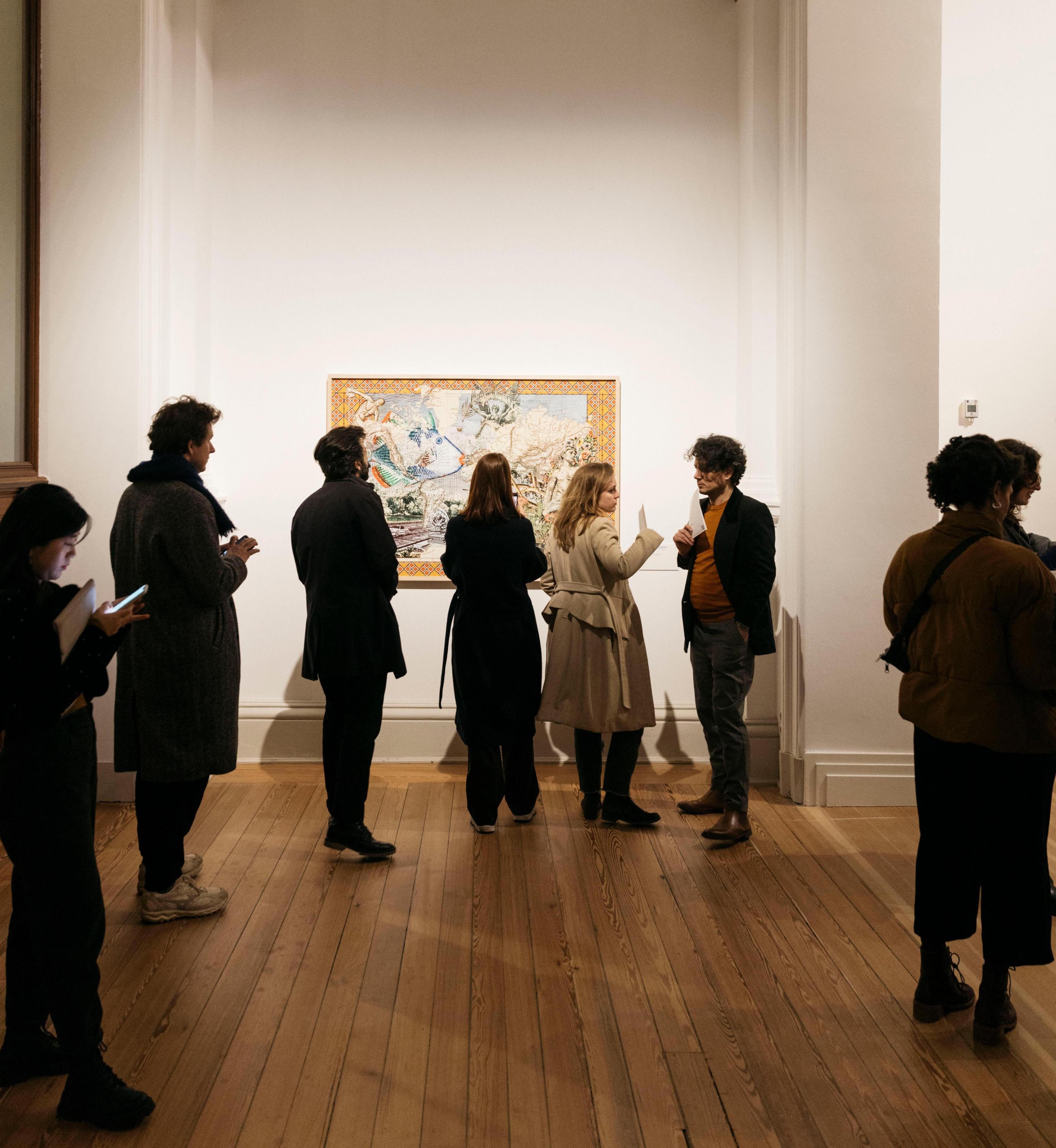 Several people are standing in an exhibition room.